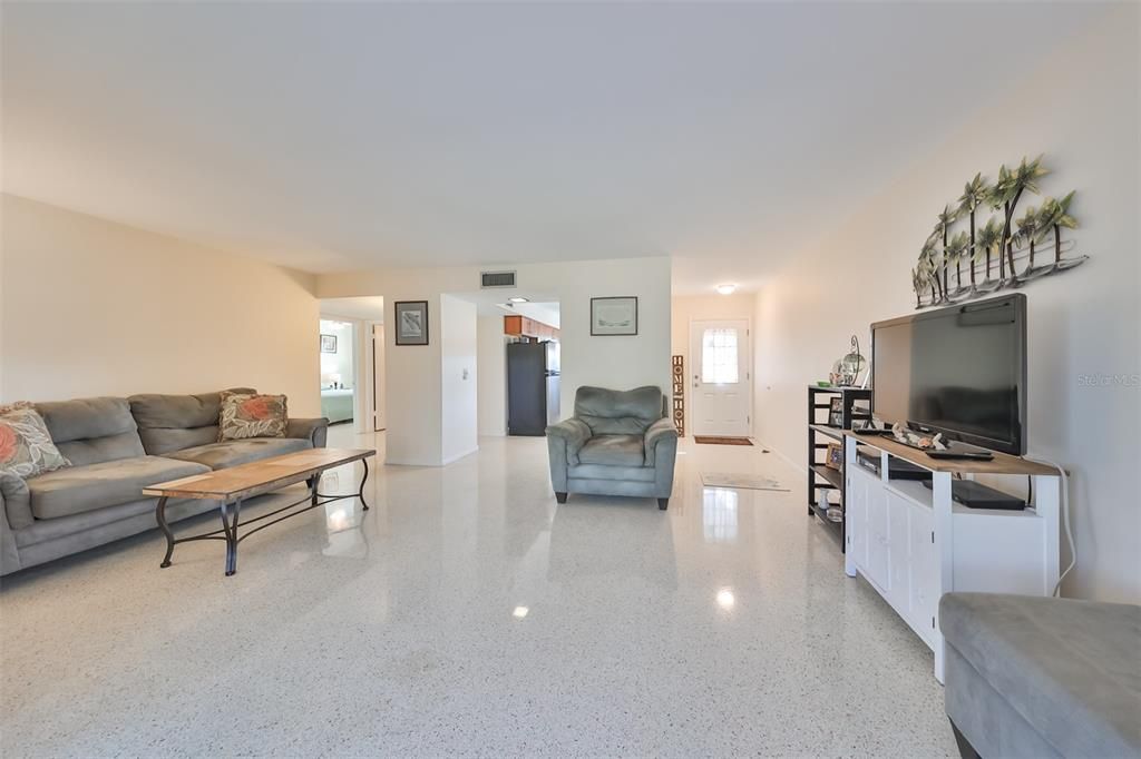 From the front door you walk into a spacious, clean and bright great room.  Notice the shiny, sparkling terrazzo floors.