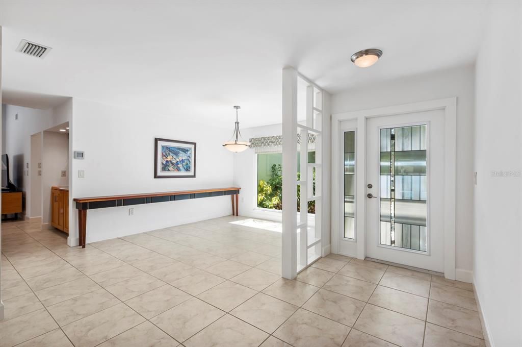 Impact Lead Glass front door opens to Dining room with Picture Window to the right