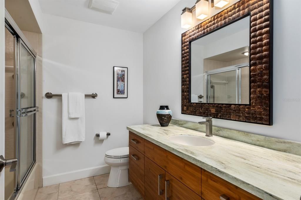 Guest Bathroom with Tub/Shower, Custom Cabinet and Solid Surface Counter