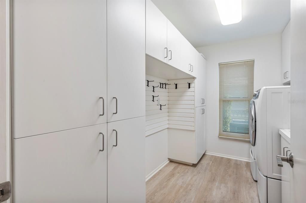 Fabulous Laundry Room with Cabinet and Closet Storage with Organization System.
