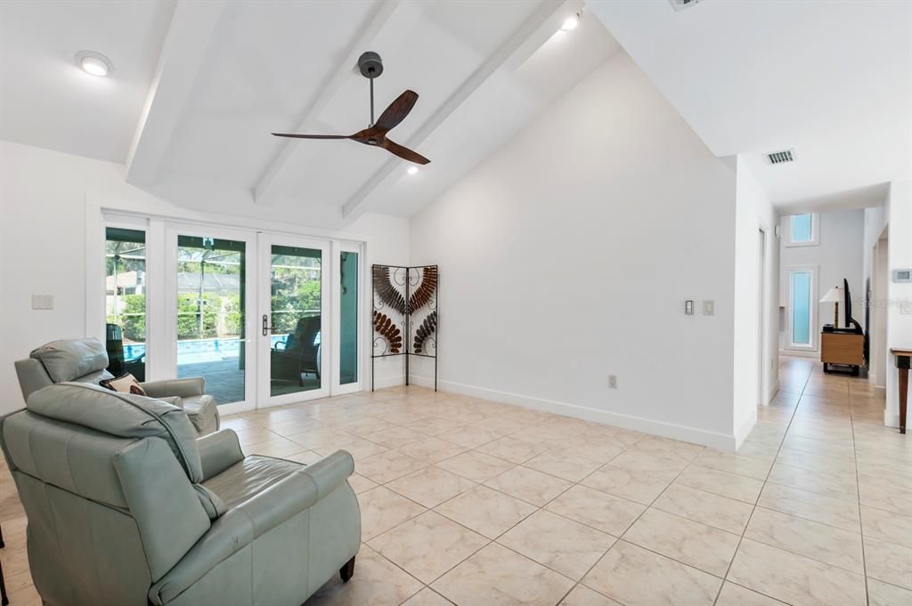 Living Room has Cathedral Ceilings and opens to the outdoors.  French Doors to Lanai.