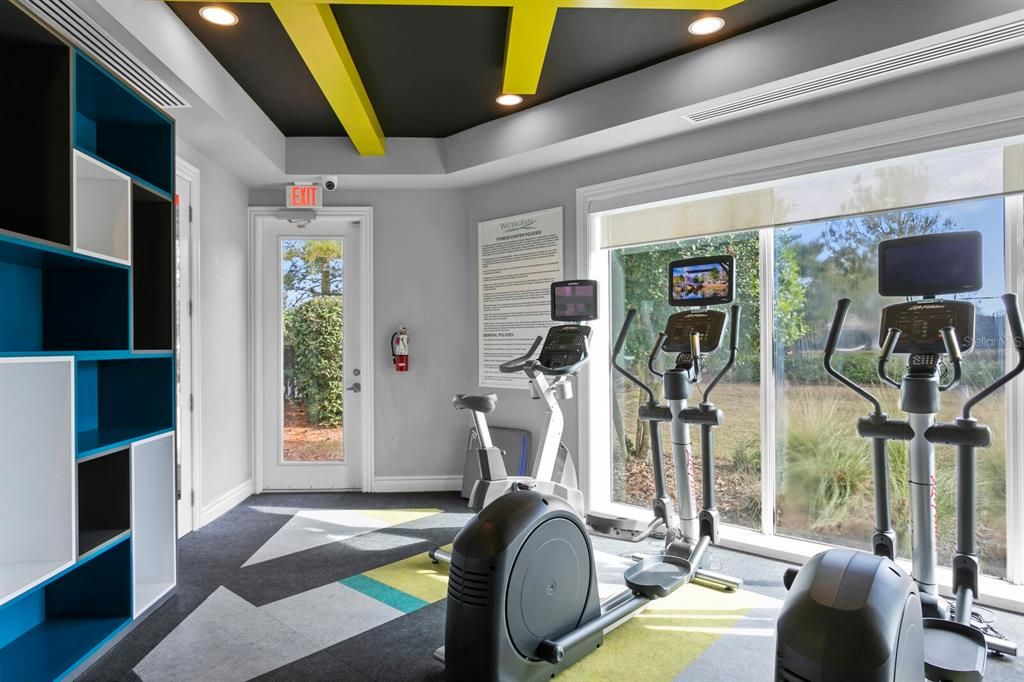 Fitness center has playroom, free weights, cardio, full shower/bathroom.