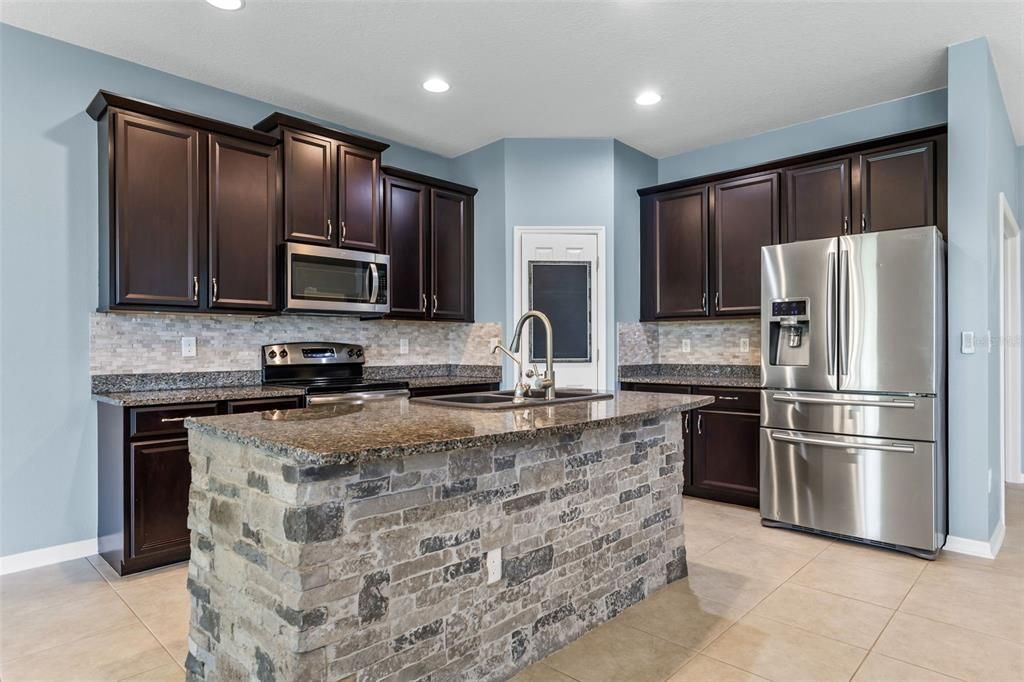 Your kitchen has tons of character & view of the living area and backyard.