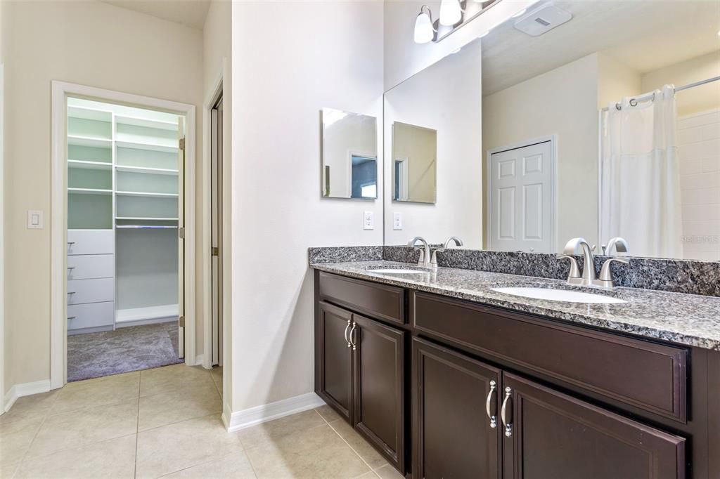 Ensuite bath has dual sinks, walk in shower, & custom built ins for the walk in closet.