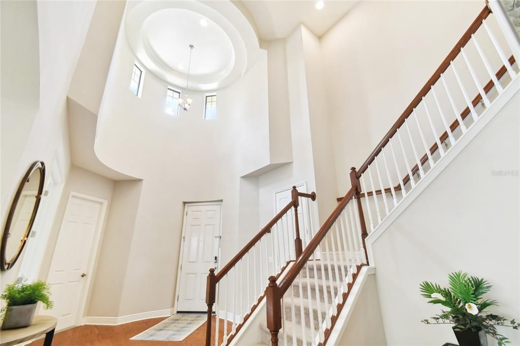 Soaring Ceiling.  Door to left goes to 1 car garage.  Door in the middle is front entry.  Door to the right is a storage closet.