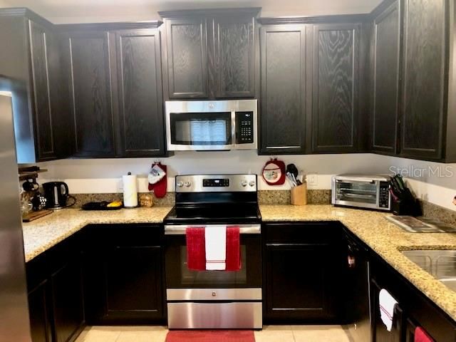 Kitchen with range and microwave, dishwasher and refrigerator/freezer