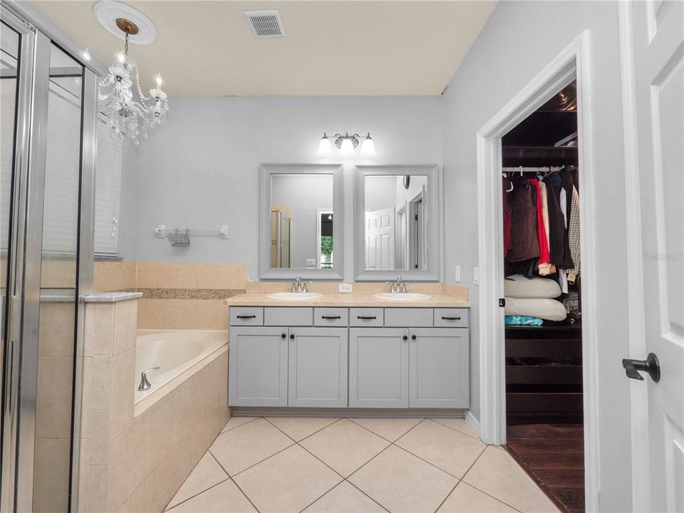 Primary Bathroom with Garden Tub, Dual Vanities, Large Shower, & Walk-In Closet (California Style Shelving)