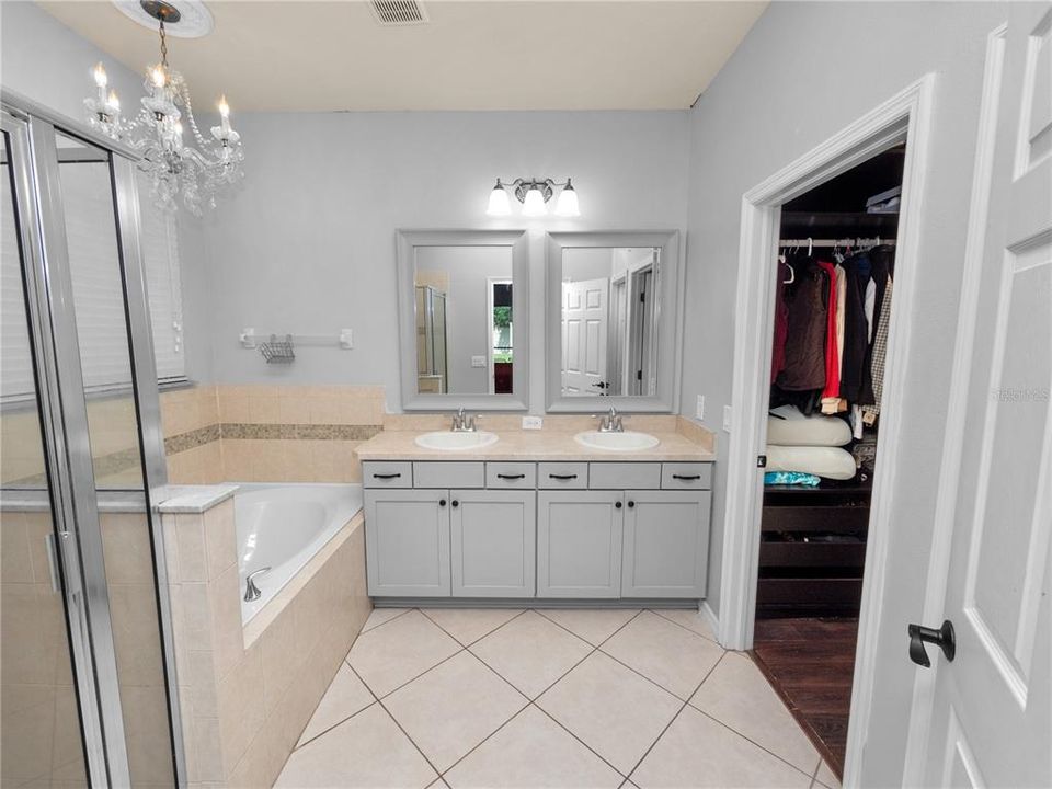 Primary Bathroom with Garden Tub, Dual Vanities, Large Shower, & Walk-In Closet (California Style Shelving)