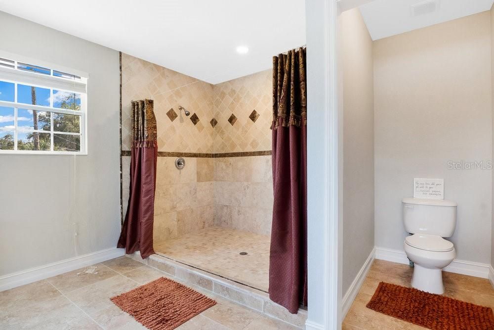 Primary Bathroom. Double sinks. Travertine Flooring. Giant shower with dual shower heads. Toilet Closet. Jetted tub.