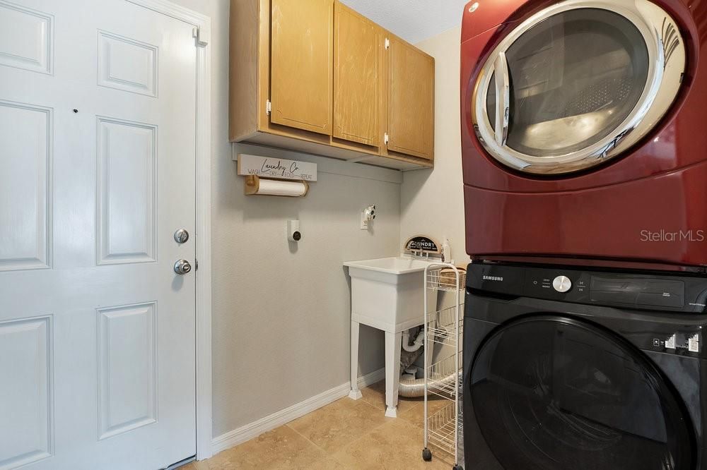 Downstairs Laundry Room with storage and utility sink.