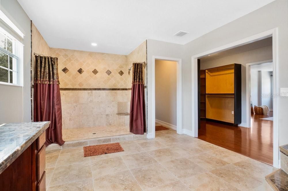Primary Bathroom. Double sinks. Travertine Flooring. Giant shower with dual shower heads. Toilet Closet. Jetted tub.