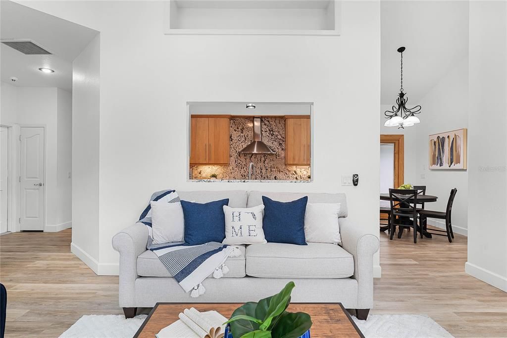 Kitchen has opening to see into Family room