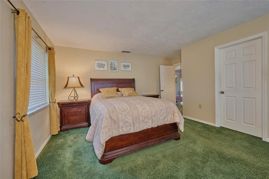 Master bedroom with view of entrance and closet door.