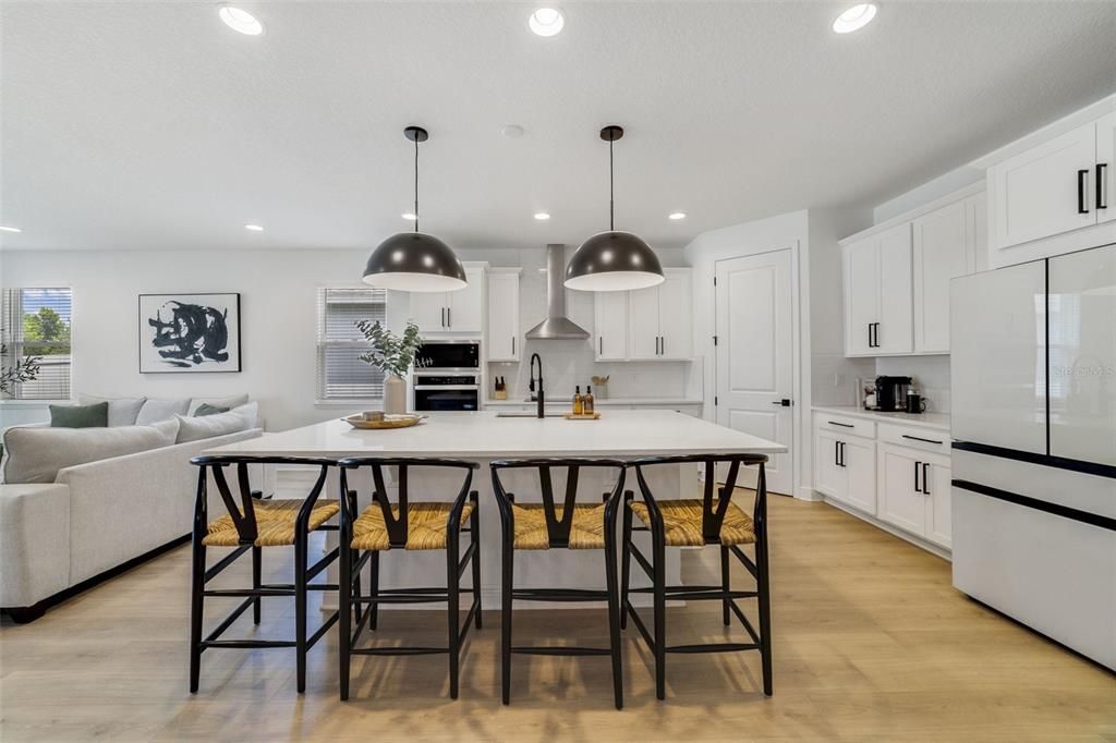Your foyer opens up to the home chef’s dream kitchen featuring a fresh modern color palette of black, gray and white, STAINLESS STEEL APPLIANCES, walk-in pantry for ample storage and a breakfast bar on the large ISLAND for casual dining or entertaining.