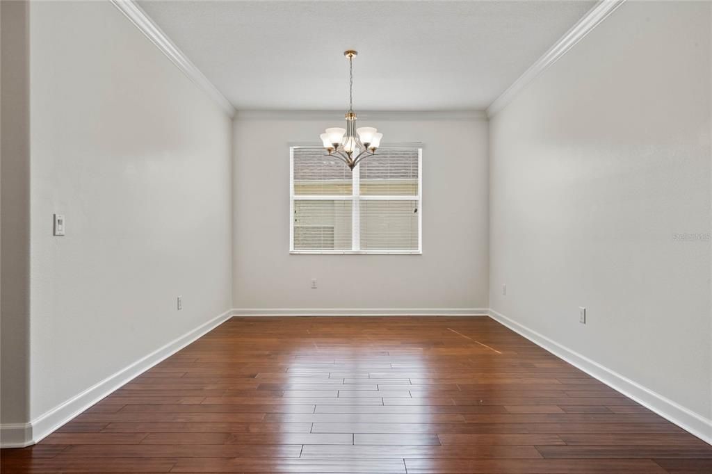 Formal Dining Room with Crown Molding and Hand Scraped Hardwood Flooring