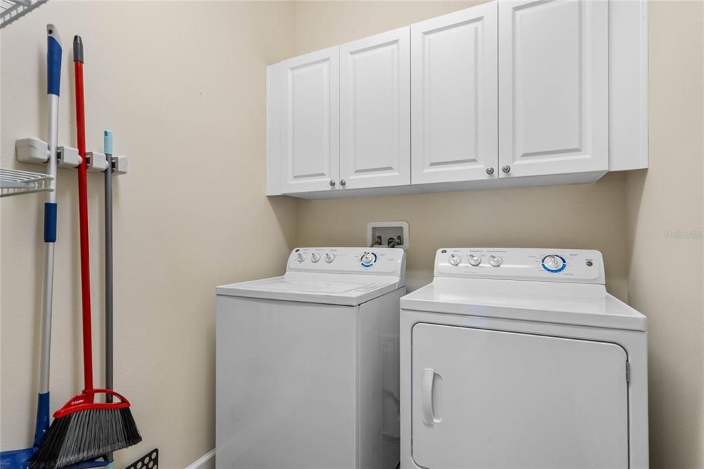 Laundry Room includes a washer, dryer and is enhanced with additional cabinetry