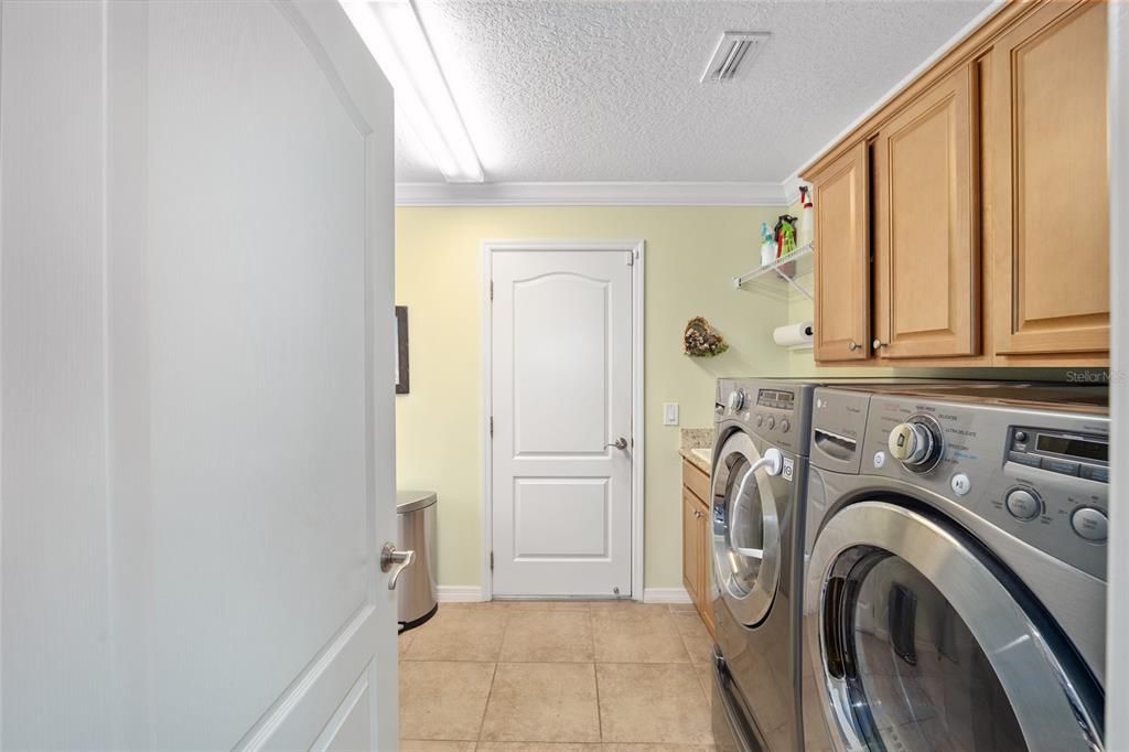 Inside Laundry with Utility Sink & Washer/Dryer on Risers