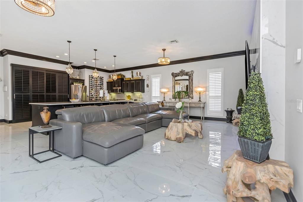 Spacious living room with gorgeous Bianco Onice Polished Porcelain tile floor