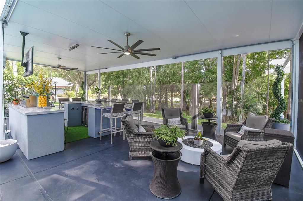 One of the seating areas on the covered lanai with Christopher Knight luxury seating and lighted gas fire pit as center table.