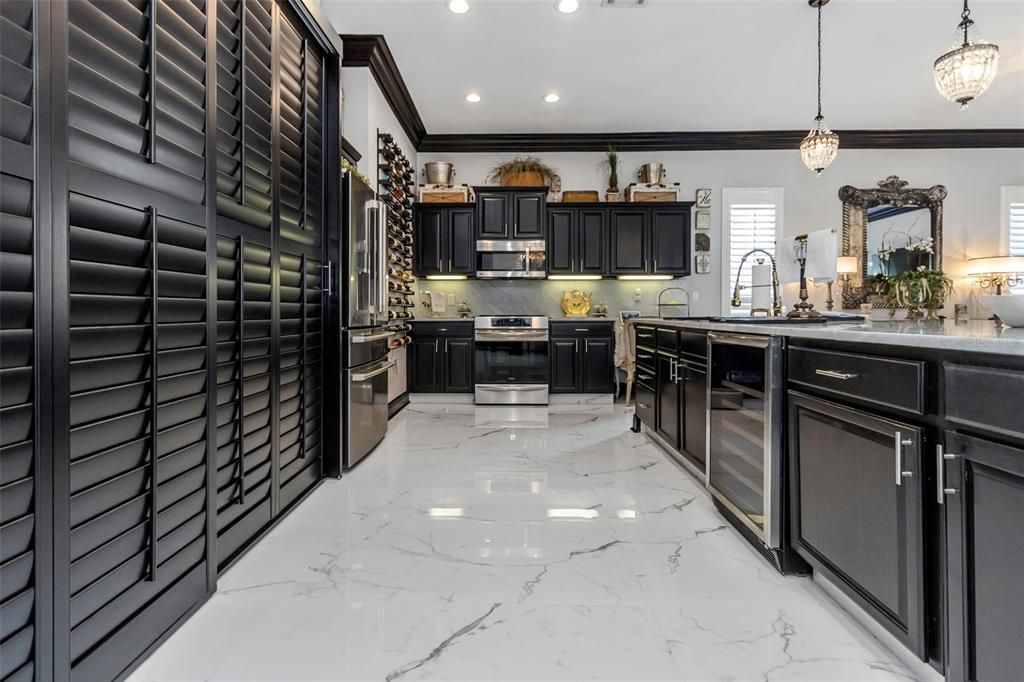 All stainless-steel appliances, to include GE Cafe Refrigerator and Microwave, Frigidaire Gallery Range. Also boasts an undercabinet Beverage Refrigerator, solid wood cabinetry and large pantry storage