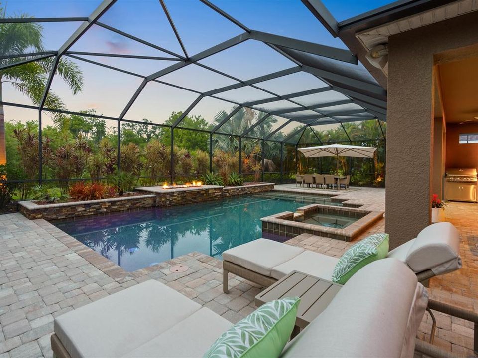 Relax in your secluded backyard; lush landscaping, a huge caged pool and a preserve beyond...