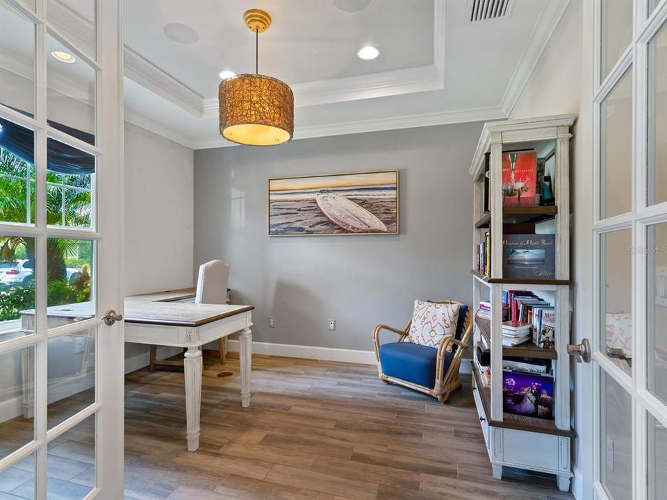 First floor office with French glass doors and tray ceiling.