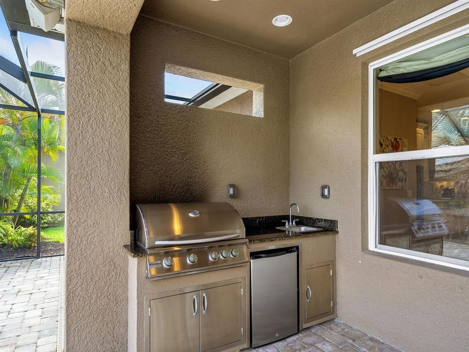 Outdoor kitchen with beverage refrigerator.