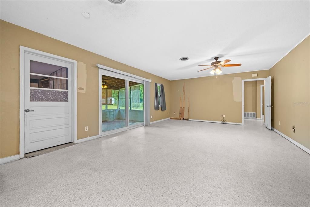 Door to Storage Room and Sliders to Lanai