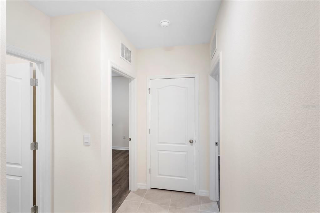Split Plan: Hallway off Dining Area Leading to Secondary Bedrooms and Bathroom.