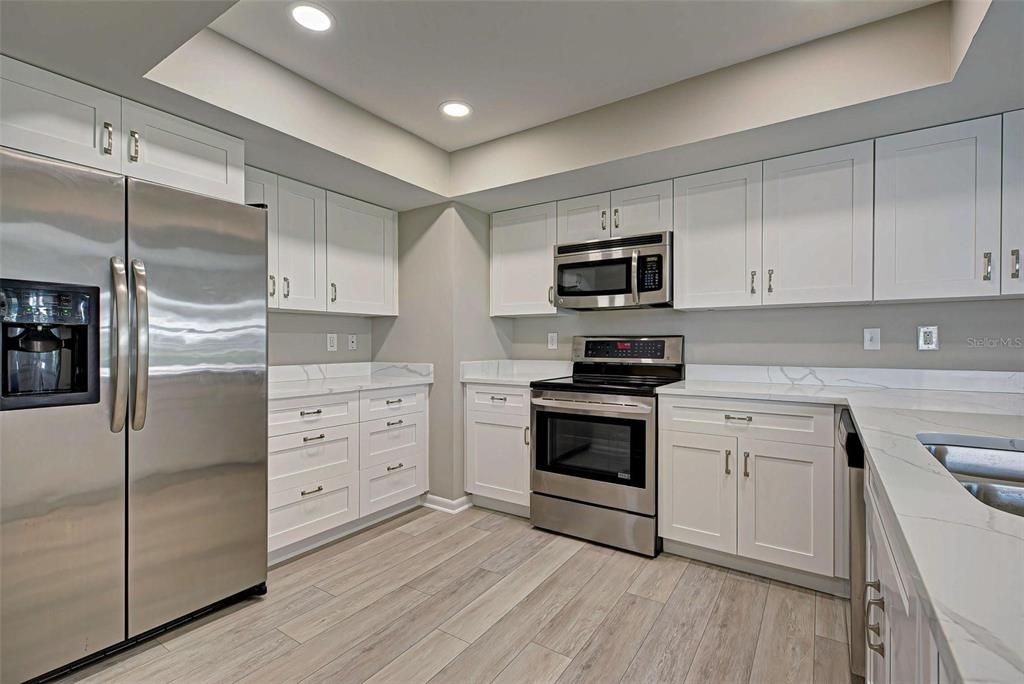 Chef's kitchen is sure to delight with its quartz countertops, wood cabinets and stainless steel appliances.