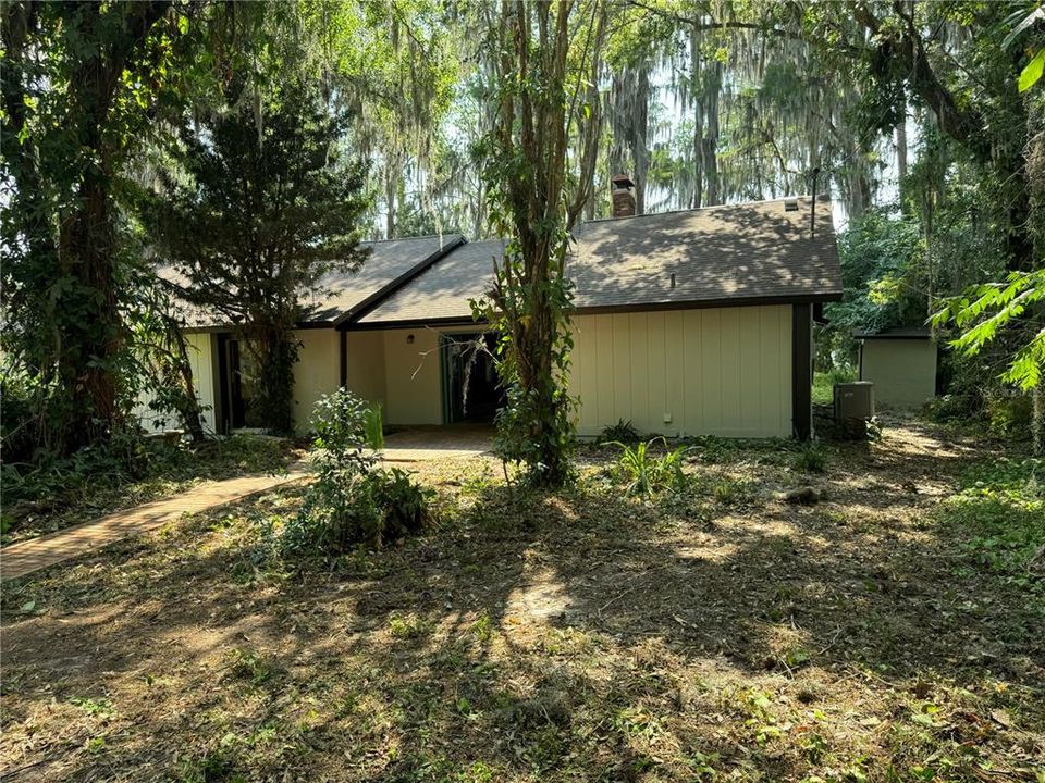 Main house with a small concrete shed to the right