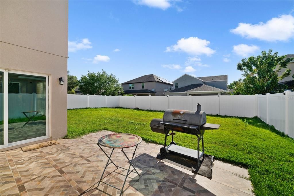 he large backyard is FULLY FENCED for added privacy and the beautiful paver patio is the perfect place to soak up some vitamin D or host a weekend cookout.