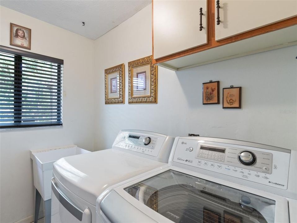 Inside utility room with storage & window