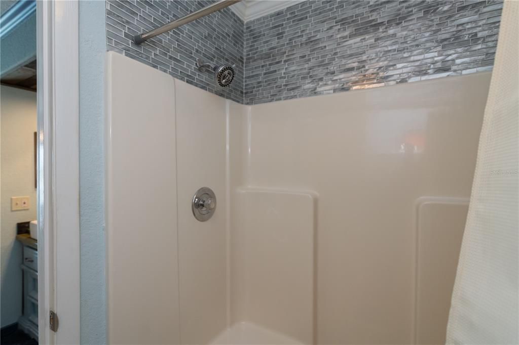 finished shower in primary bedroom bathroom