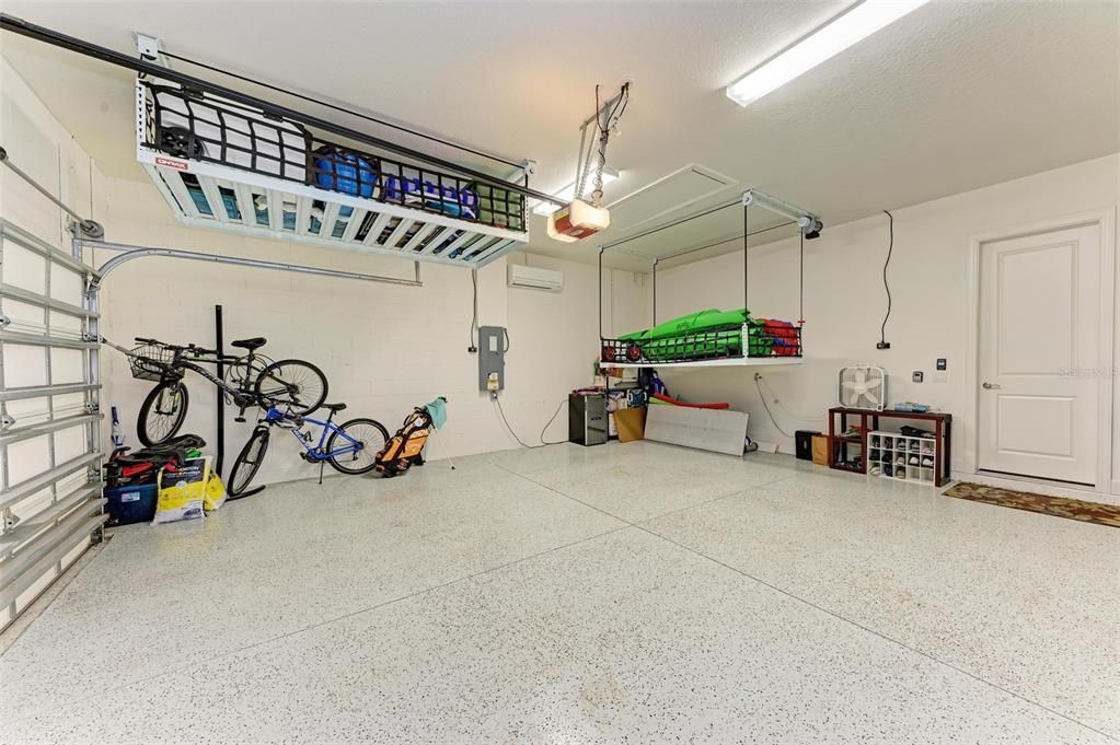 Air conditioned garage with motorized lift storage