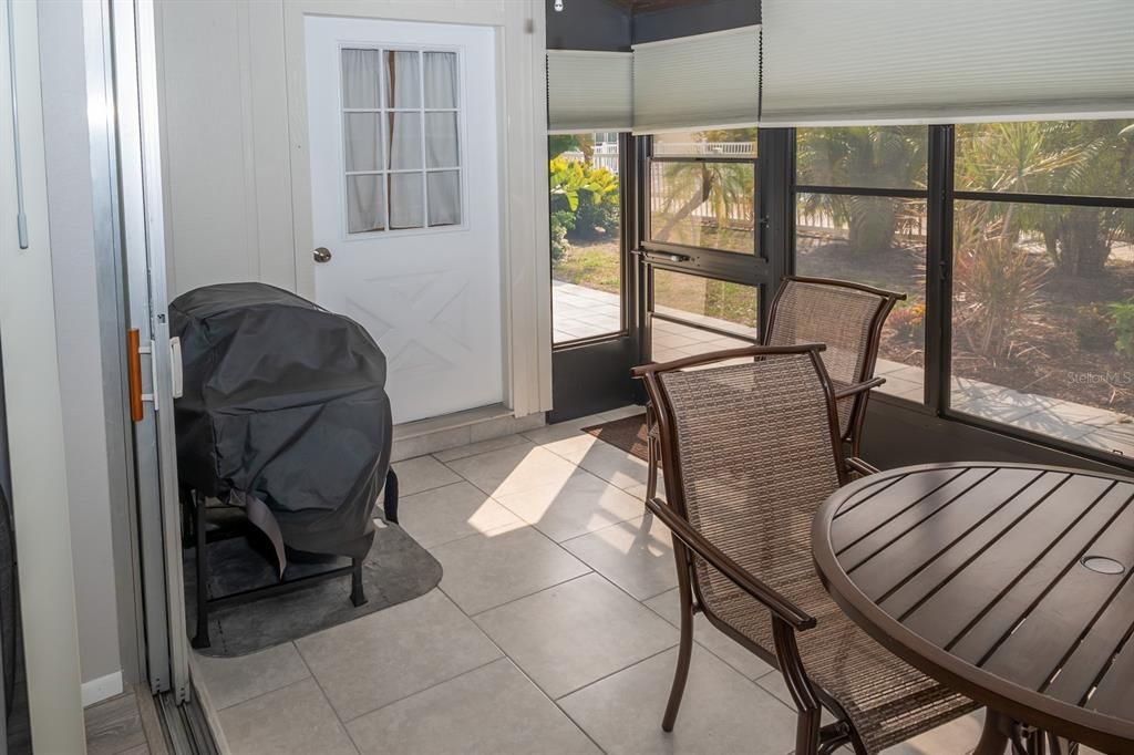 Access door to the Primary Bedroom, and rear screened-in door to the lovely patio and pool.