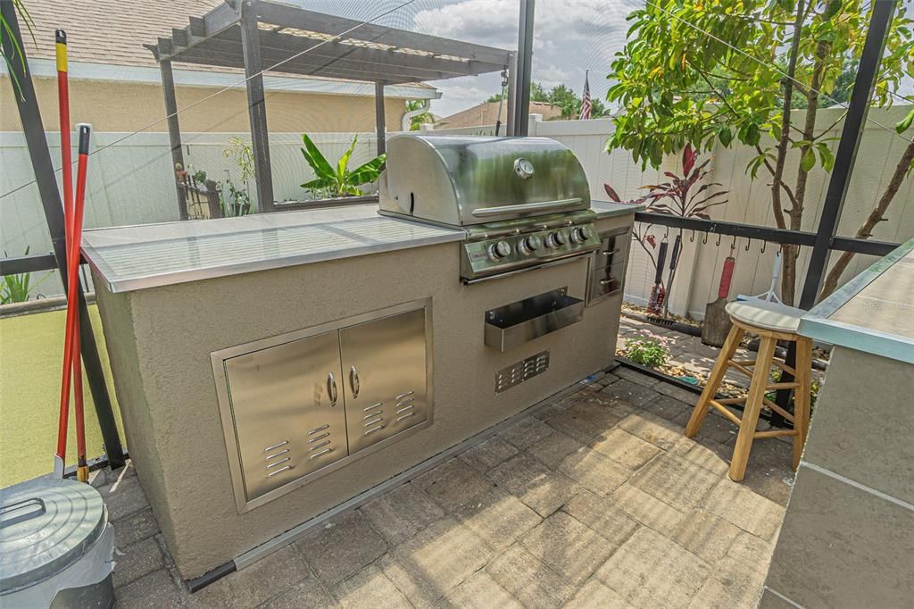 Gorgeous built in grilling area with stainless steel cabinets and stone countertops