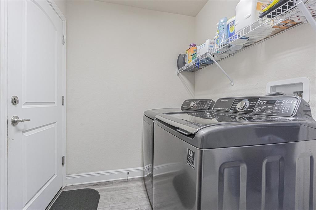 Spacious laundry room between kitchen and garage
