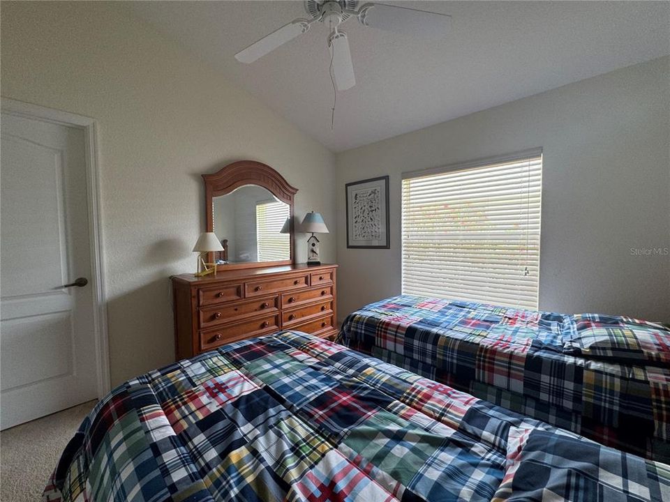 Second Bedroom: The guest bedroom is comfortably furnished with large windows, ample closet space, and two twin beds, providing a cozy and welcoming space for guests.