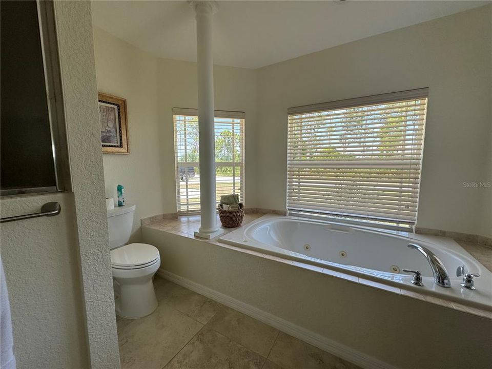 Master Bathroom: A spa-like bathroom with dual vanities, a soaking tub, and a separate shower sets the stage for relaxation and rejuvenation, providing a luxurious escape within the home.