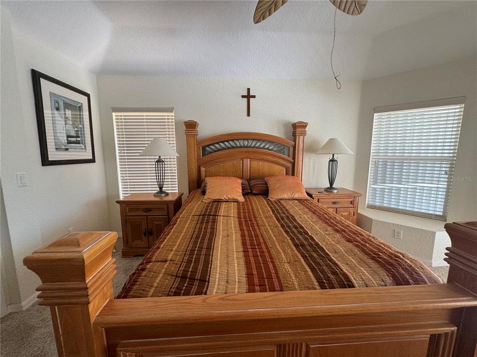 Large master suite featuring a king-sized beds, a walk-in closet, and serene outdoor views, providing a perfect retreat.
