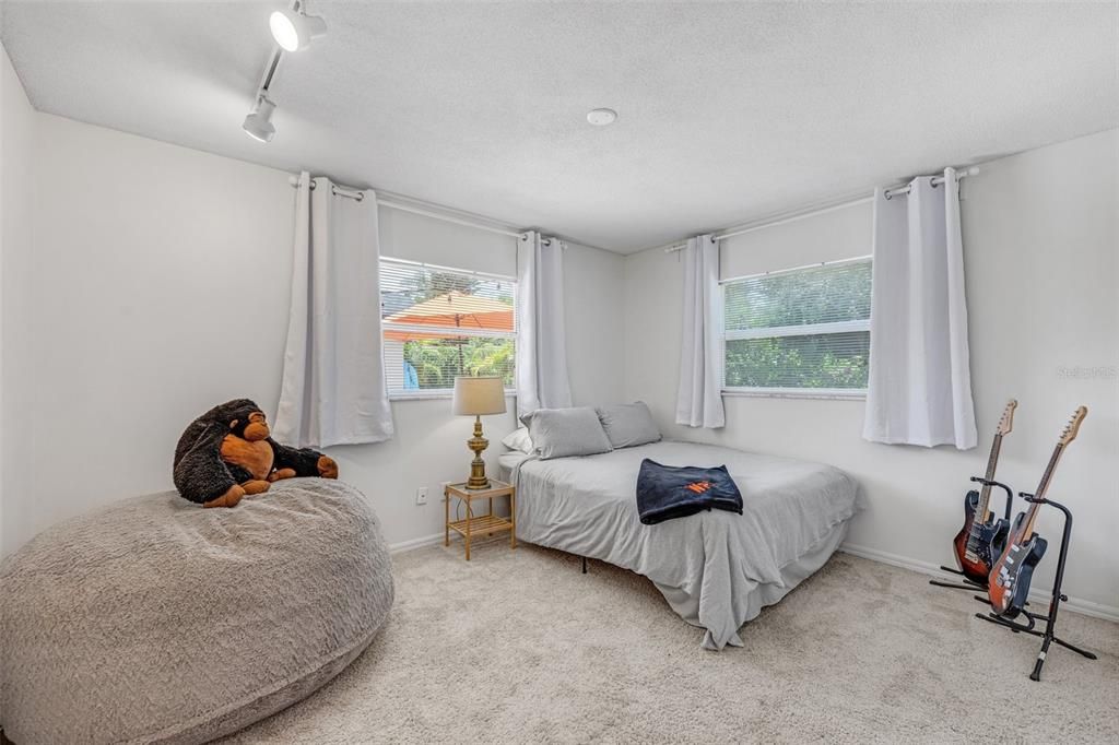 Bedroom Four has two windows with pool views.