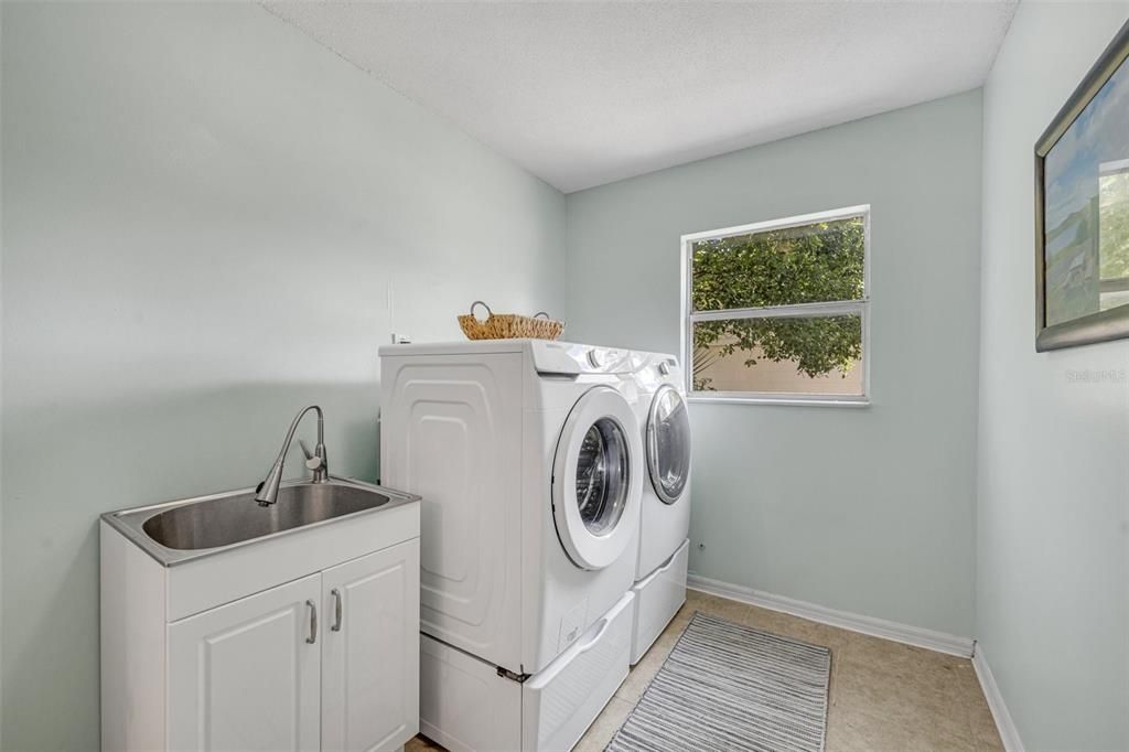 This luxurious floor plan also features a large interior laundry room with a utility sink and storage closet.
