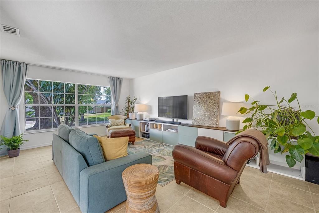 The front living room offers bright views of the front yard situated on a cul-de-sac.