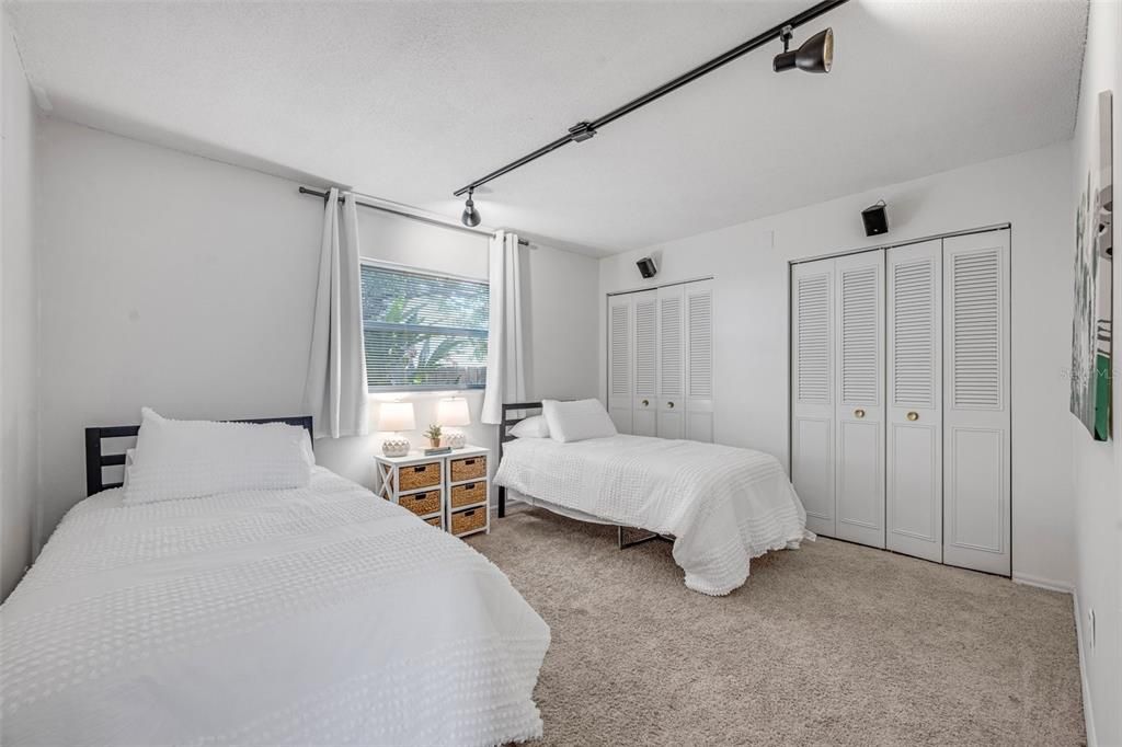 This guest bedroom includes dual closets.