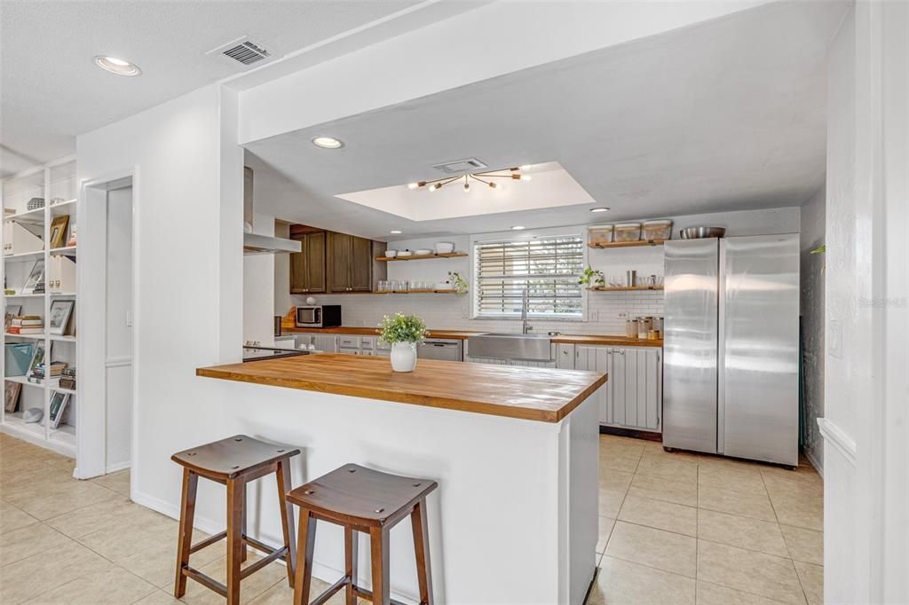 A breakfast bar connects the spacious kitchen and family room.