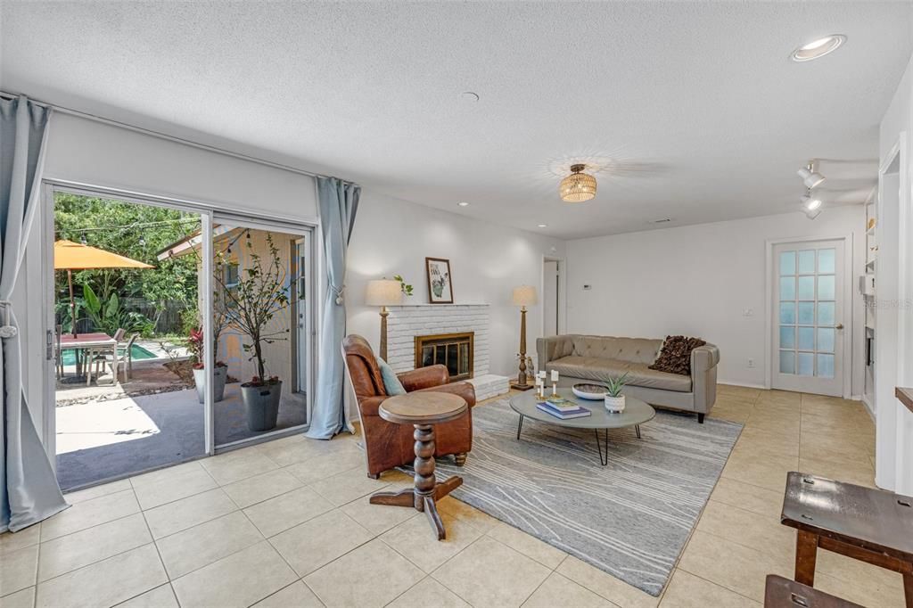 A brick fireplace serves as the focal point of the family room.