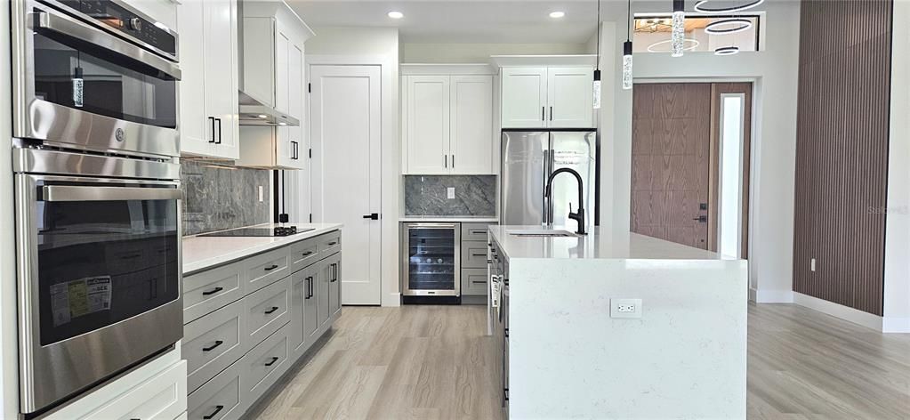 Kitchen includes all appliances including a independent wine/bottle cooler, lighting under counter, under and above cabinets, pendant lighting, external vent