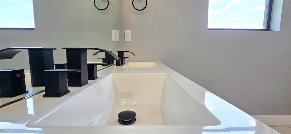 Master bath includes fully tiled walk-in shower with glass doors, dual sink vanity, private water closet