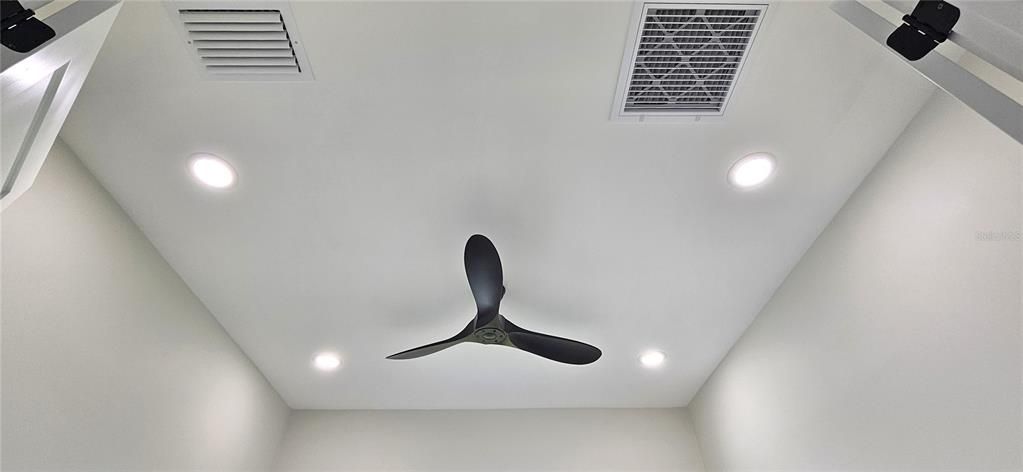 Studio/office includes modern ceiling fan and 4 can lighting fixtures